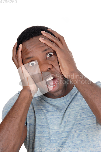 Image of Upset African man screaming with hands on head