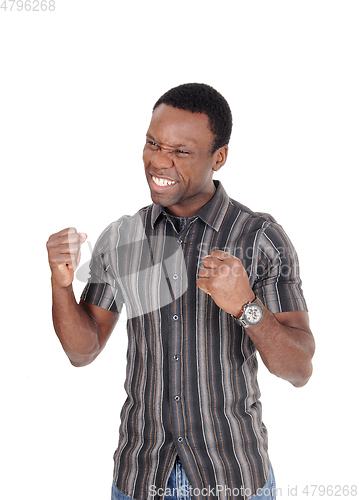 Image of Happy African man making fists, smiling