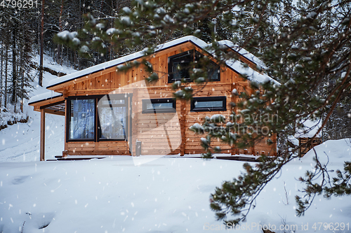 Image of Winter holiday house in forest.