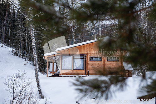 Image of Winter holiday house in forest.