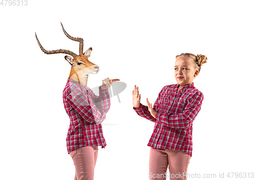 Image of Young handsome girl arguing with herself as a deer on white studio background.