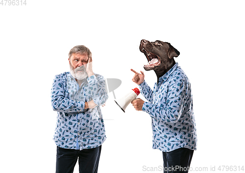Image of Senior man arguing with himself as a dog on white studio background.