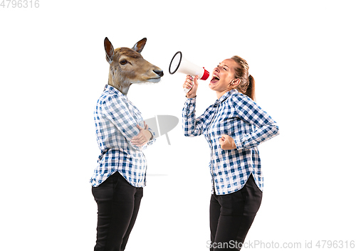 Image of Young handsome woman arguing with herself as a deer on white studio background.