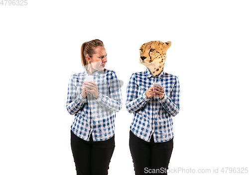 Image of Young handsome woman arguing with herself as a leopard on white studio background.