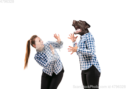 Image of Young handsome woman arguing with herself as a dog on white studio background.