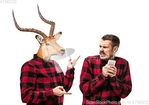 Image of Man arguing with himself as a deer on white studio background.
