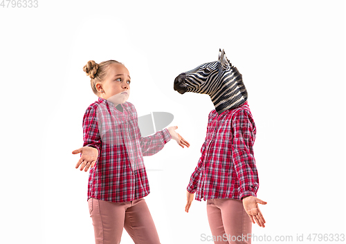 Image of Young handsome girl arguing with herself as a zebra on white studio background.