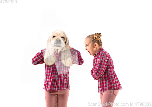 Image of Young handsome girl arguing with herself as a dog on white studio background.