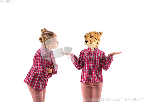 Image of Young handsome girl arguing with herself as a leopard on white studio background.