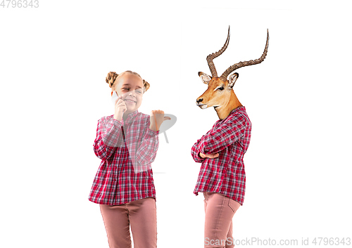 Image of Young handsome girl arguing with herself as a deer on white studio background.