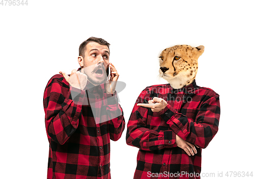 Image of Man arguing with himself as a leopard on white studio background.