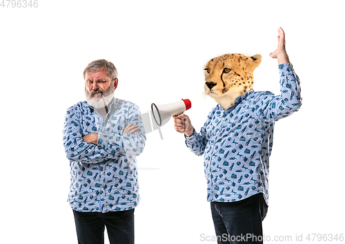 Image of Senior man arguing with himself as a leopard on white studio background.