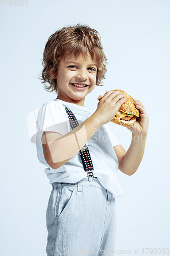 Image of Pretty young boy in casual clothes on white studio background