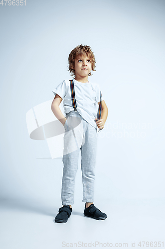 Image of Pretty young boy in casual clothes on white studio background