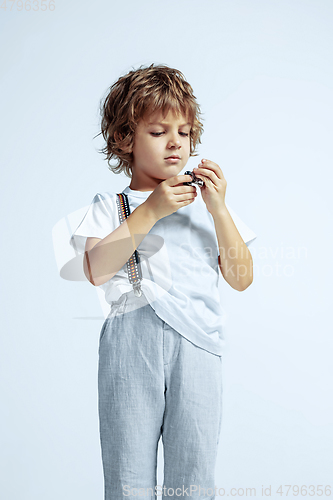 Image of Pretty young boy in casual clothes on white studio background