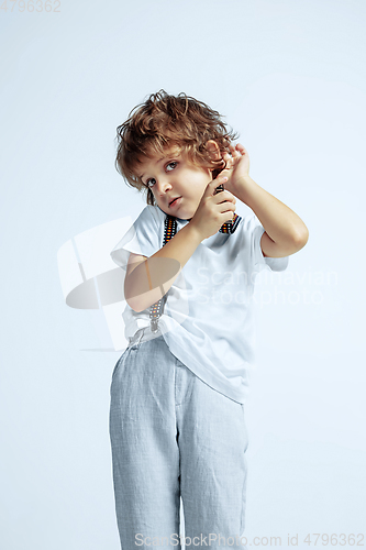 Image of Pretty young boy in casual clothes on white studio background