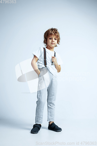 Image of Pretty young boy in casual clothes on white studio background