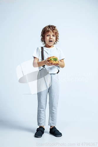 Image of Pretty young boy in casual clothes on white studio background