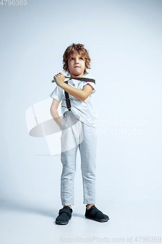 Image of Pretty young boy in casual clothes on white studio background