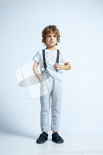 Image of Pretty young boy in casual clothes on white studio background