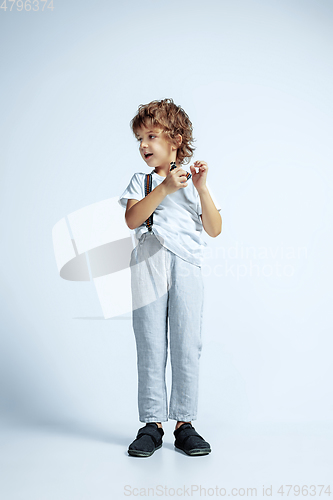 Image of Pretty young boy in casual clothes on white studio background