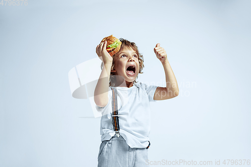 Image of Pretty young boy in casual clothes on white studio background