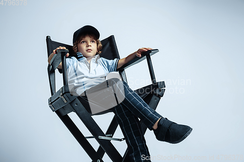 Image of Pretty young boy in casual clothes on white studio background