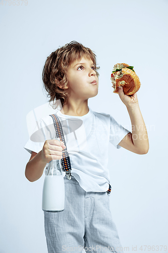 Image of Pretty young boy in casual clothes on white studio background