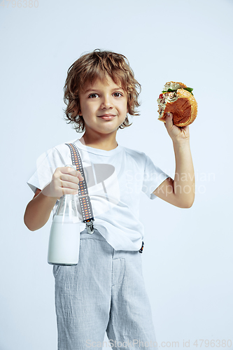 Image of Pretty young boy in casual clothes on white studio background