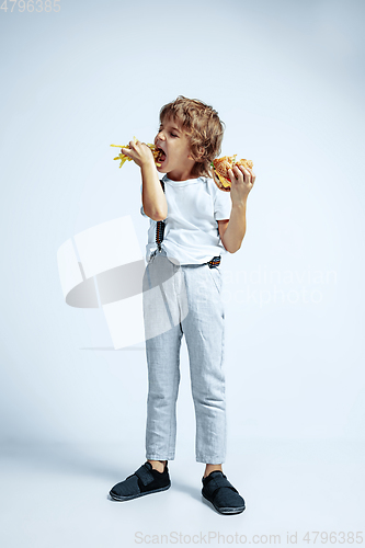 Image of Pretty young boy in casual clothes on white studio background