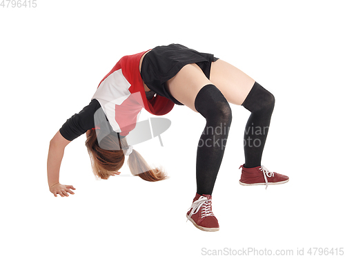 Image of Young woman making a bridge on the floor