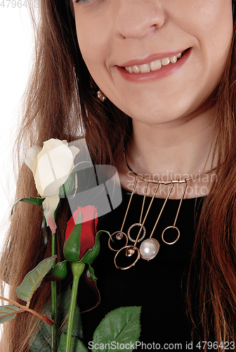 Image of Close up of the necklace and mouth of woman