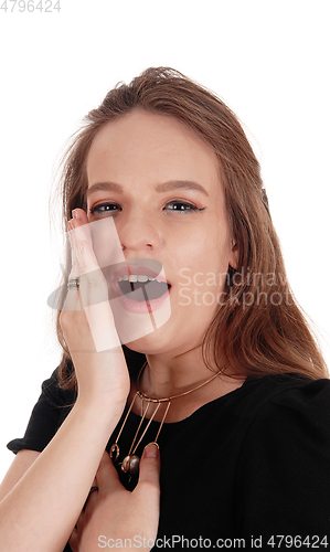 Image of Woman talking behind her hand
