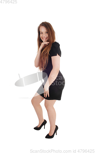 Image of Beautiful woman standing in a black dress
