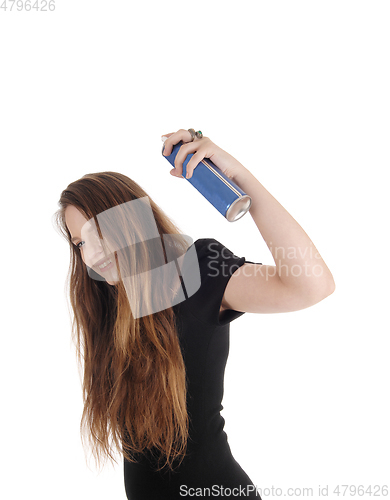 Image of Woman putting hair spray on her hair