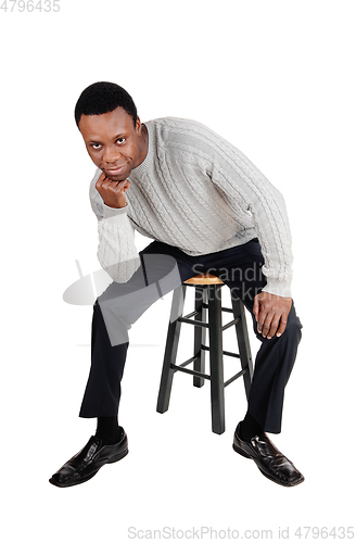 Image of African man sitting on chair and thinking