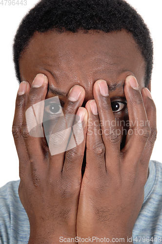 Image of African man holding his hands over face