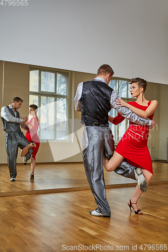 Image of beautiful couple dancing tango