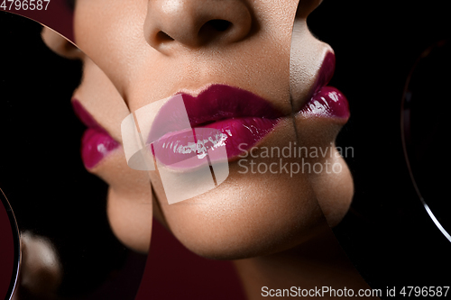 Image of beautiful woman lips closeup with mirror reflections