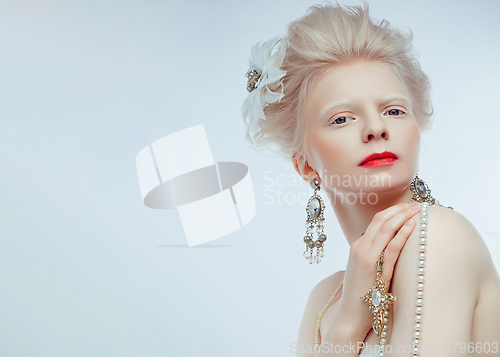 Image of beautiful albino girl with red lips on white background
