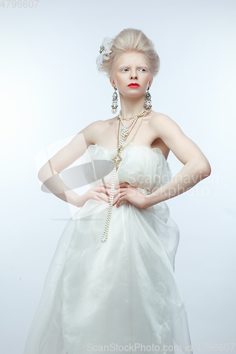 Image of beautiful albino girl with red lips on white background