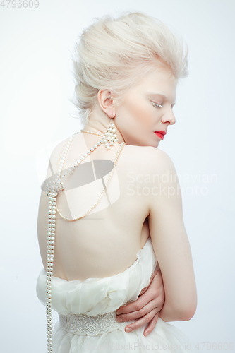 Image of beautiful albino girl with red lips on white background