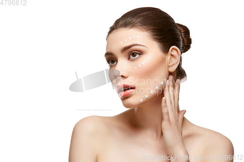 Image of girl applying foundation on face isolated on white