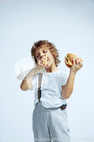 Image of Pretty young boy in casual clothes on white studio background