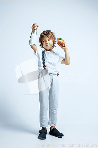 Image of Pretty young boy in casual clothes on white studio background