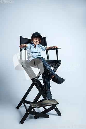 Image of Pretty young boy in casual clothes on white studio background