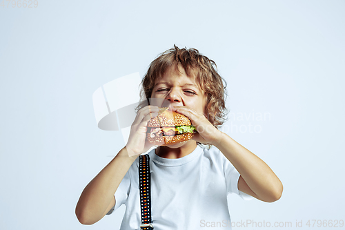 Image of Pretty young boy in casual clothes on white studio background