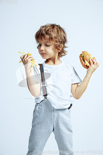 Image of Pretty young boy in casual clothes on white studio background