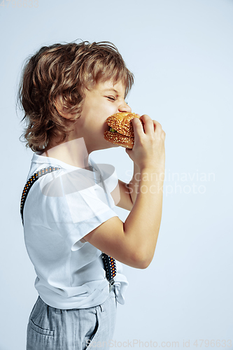 Image of Pretty young boy in casual clothes on white studio background