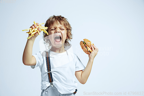 Image of Pretty young boy in casual clothes on white studio background